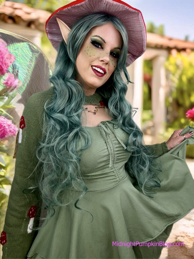 green fairy dress on mushroom fairy with hat and pointed ears